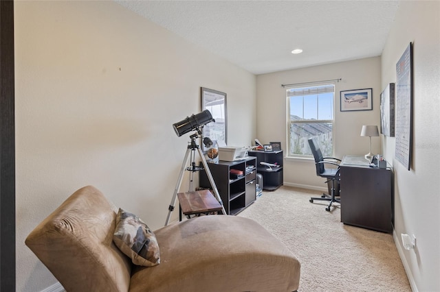 carpeted home office with baseboards