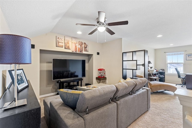 carpeted living room with ceiling fan, a textured ceiling, and lofted ceiling