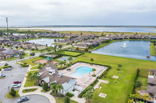 aerial perspective of suburban area with a large body of water and a pool area