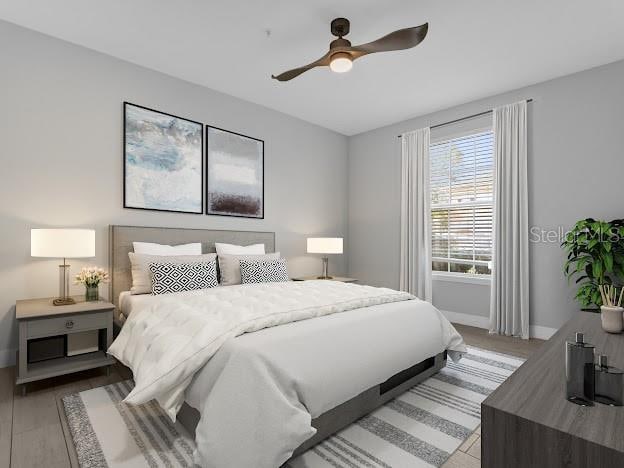 bedroom with light hardwood / wood-style floors and ceiling fan