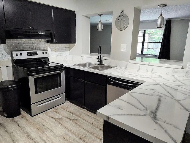 kitchen with hanging light fixtures, extractor fan, appliances with stainless steel finishes, a textured ceiling, and sink