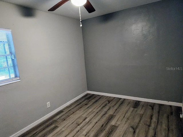 spare room with ceiling fan and dark hardwood / wood-style flooring