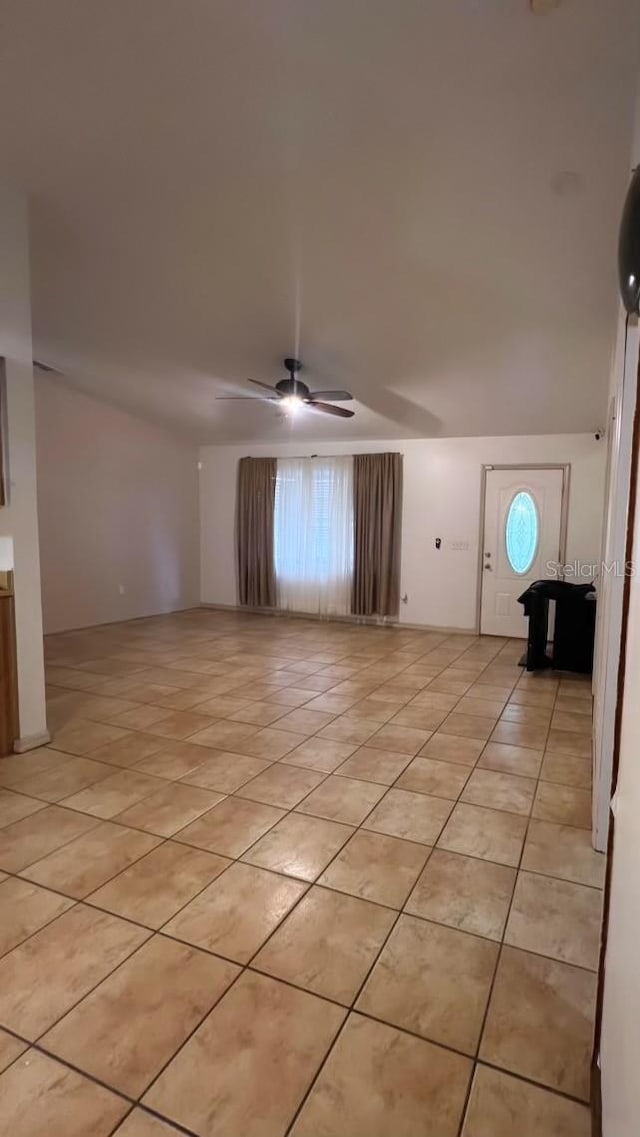 interior space featuring ceiling fan and a wealth of natural light