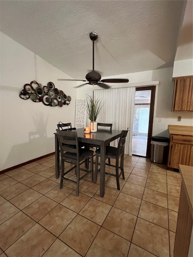 dining room featuring ceiling fan and tile patterned flooring