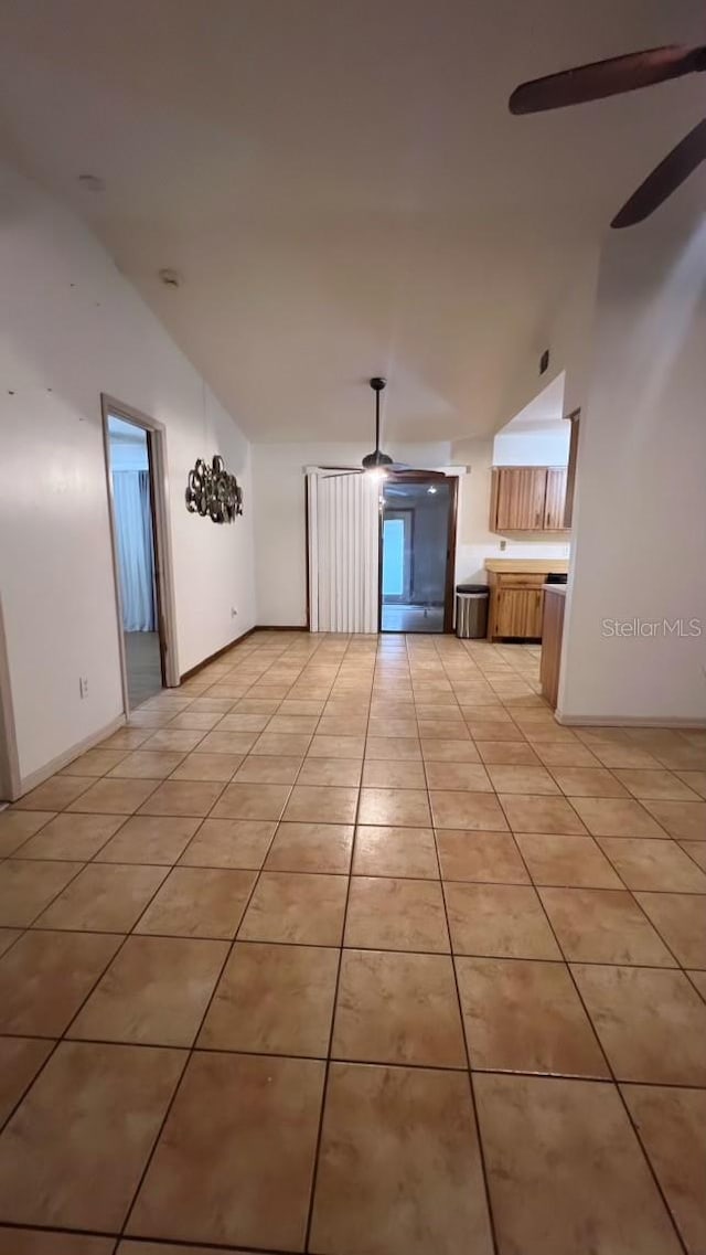 unfurnished living room with ceiling fan and light tile patterned floors