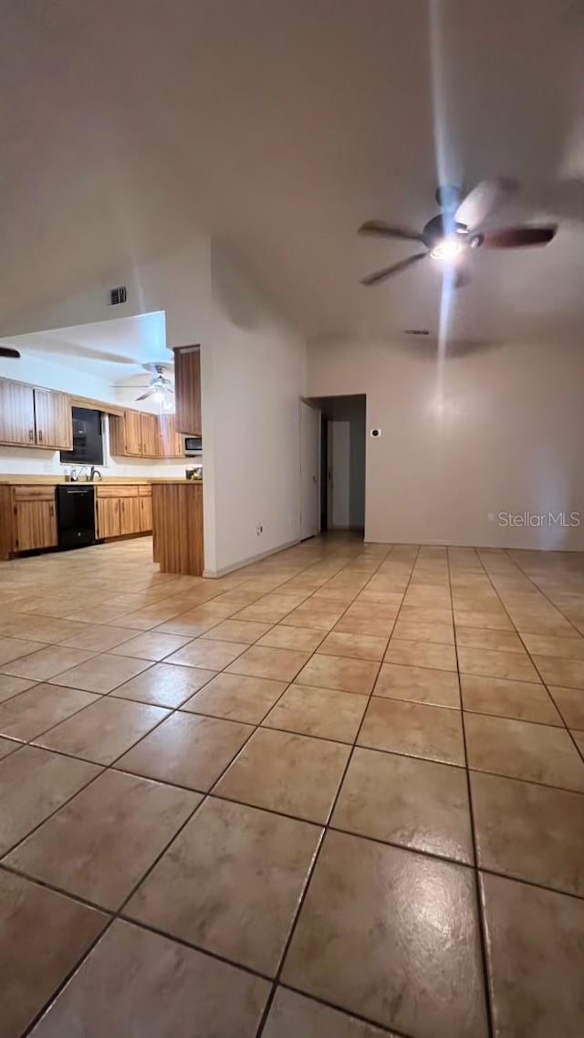 unfurnished living room featuring ceiling fan and light tile patterned floors