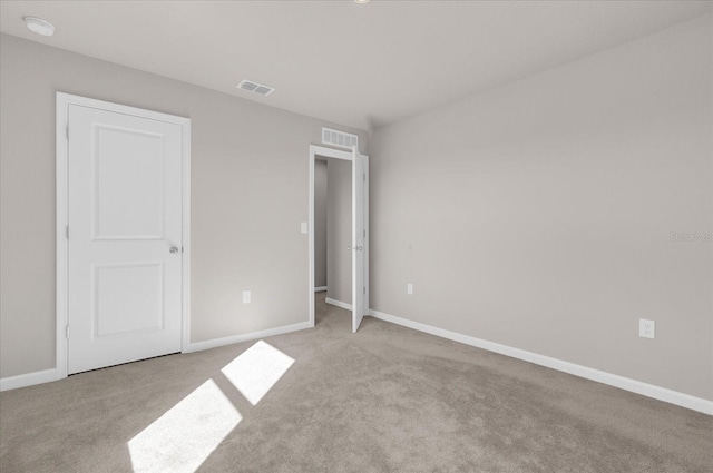 unfurnished bedroom with light colored carpet