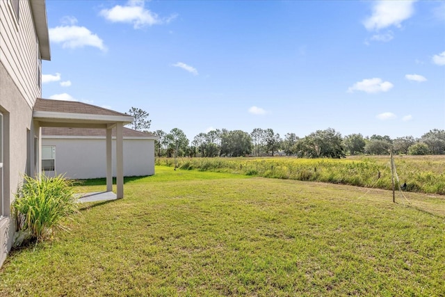 view of yard with a rural view