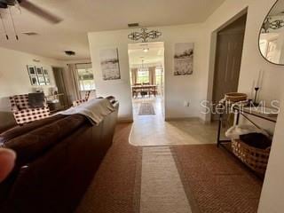 living room featuring carpet flooring and ceiling fan