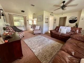 carpeted living room featuring ceiling fan