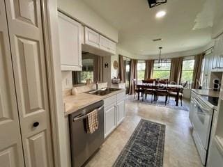 kitchen featuring white range with electric cooktop, hanging light fixtures, sink, white cabinets, and stainless steel dishwasher