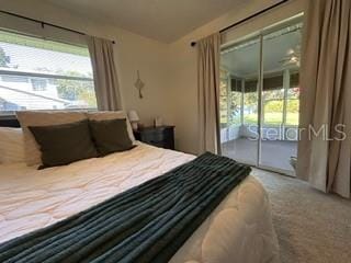 carpeted bedroom featuring access to exterior