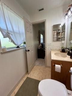 bathroom with toilet and vanity