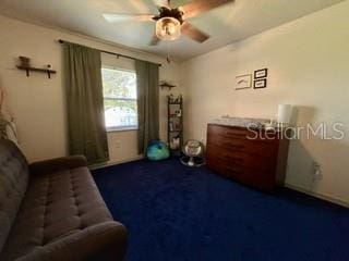 living area featuring carpet flooring and ceiling fan