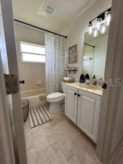 full bathroom featuring shower / bath combo, vanity, and toilet