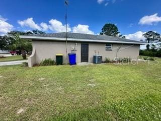 rear view of house featuring a yard