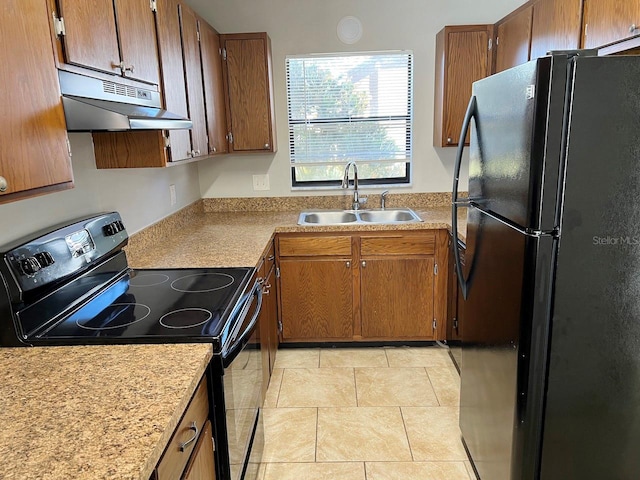 kitchen with light tile patterned floors, black appliances, and sink