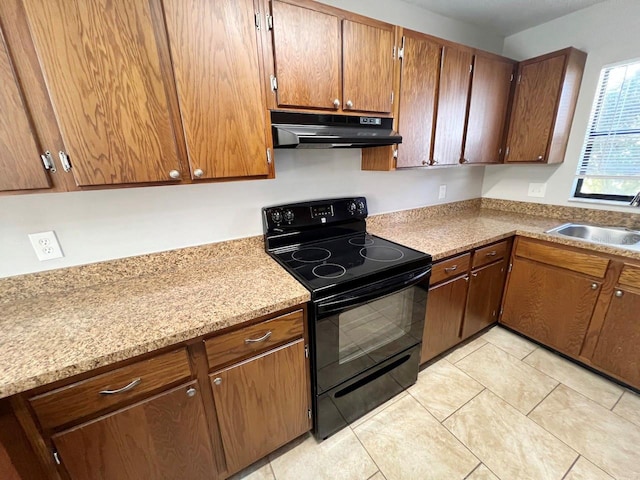 kitchen featuring black / electric stove, light tile patterned flooring, and sink