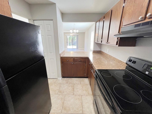 kitchen with pendant lighting, black appliances, light tile patterned floors, and a chandelier