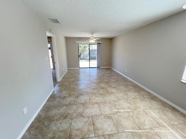 empty room featuring a textured ceiling and ceiling fan