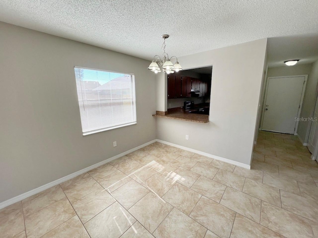 unfurnished dining area featuring a textured ceiling, an inviting chandelier, and light tile patterned floors