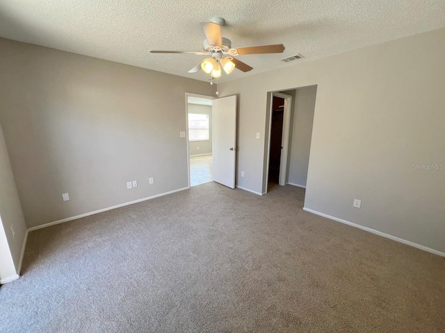 spare room featuring a textured ceiling and ceiling fan