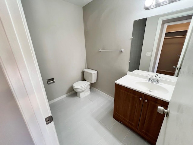 bathroom with vanity, toilet, and tile patterned floors