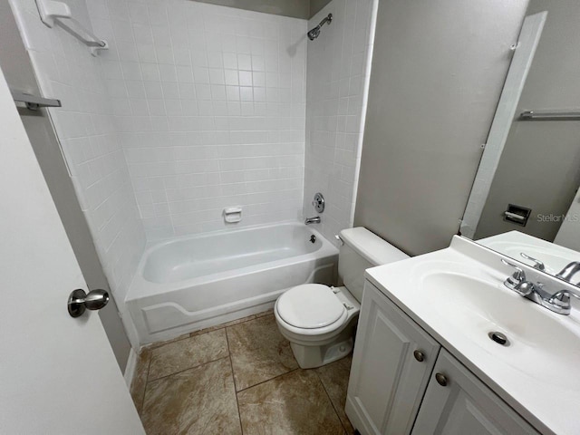 full bathroom with vanity, toilet, tile patterned flooring, and tiled shower / bath