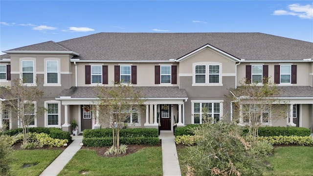 view of property featuring a front lawn