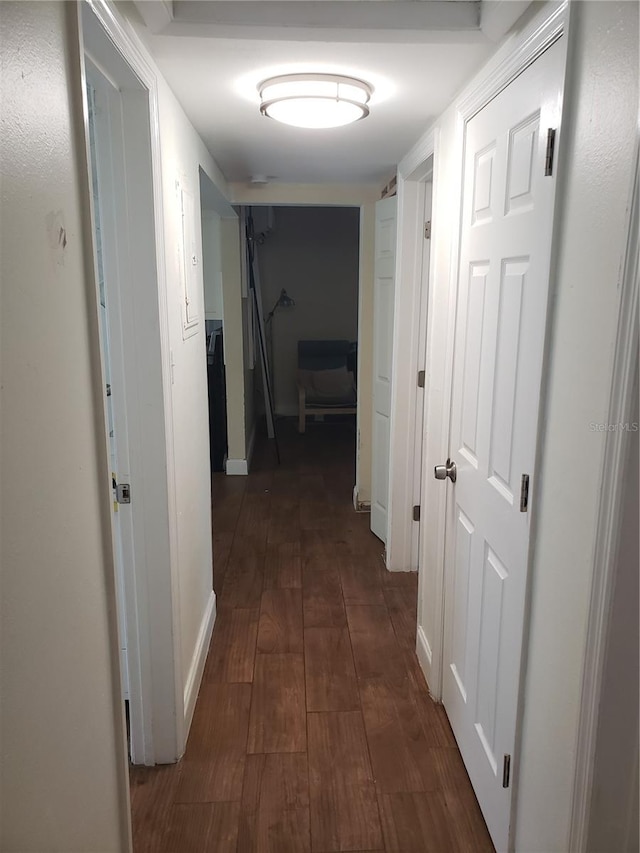 corridor with dark wood-style flooring