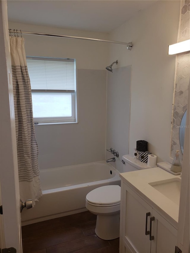 bathroom featuring toilet, shower / bath combo, wood finished floors, and vanity