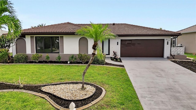 mediterranean / spanish house with a front lawn and a garage