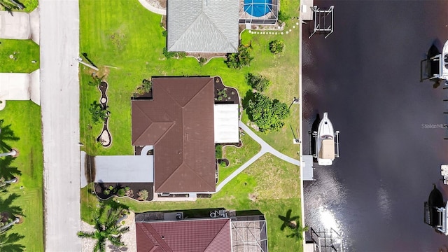 birds eye view of property with a water view