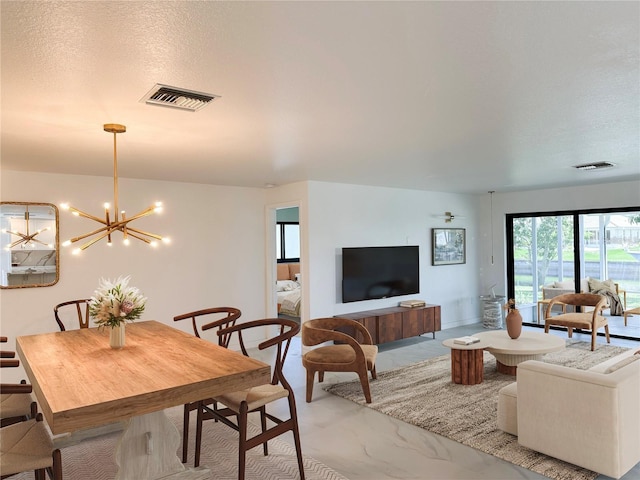 interior space featuring a chandelier and a textured ceiling