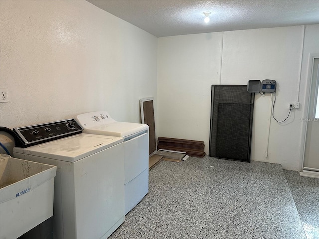 laundry room featuring sink, independent washer and dryer, and a textured ceiling