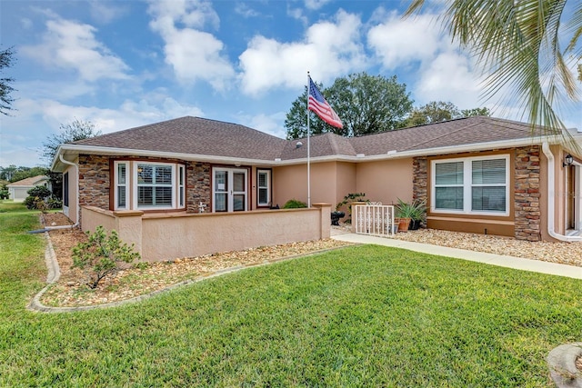 ranch-style home with a front yard