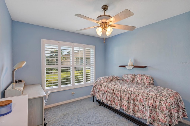 bedroom with light carpet and ceiling fan