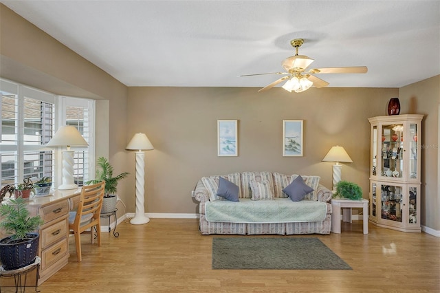 living room featuring light wood-type flooring and ceiling fan