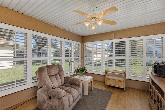 sunroom featuring ceiling fan