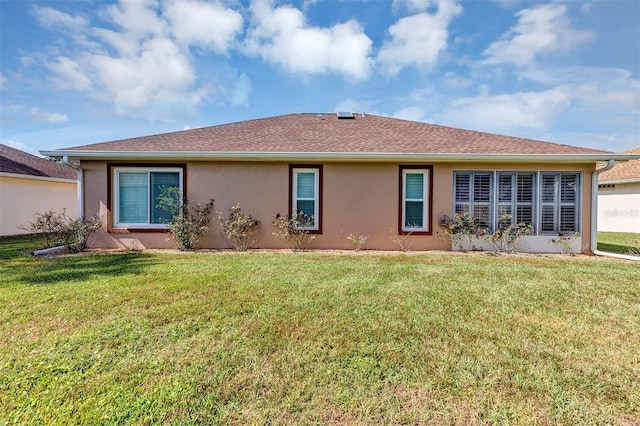 rear view of property with a lawn