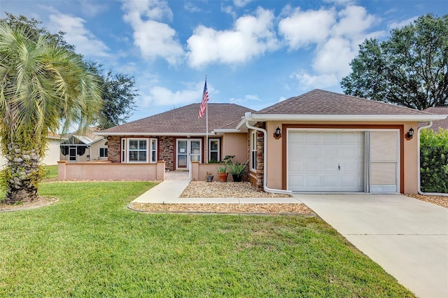 single story home with a garage and a front lawn