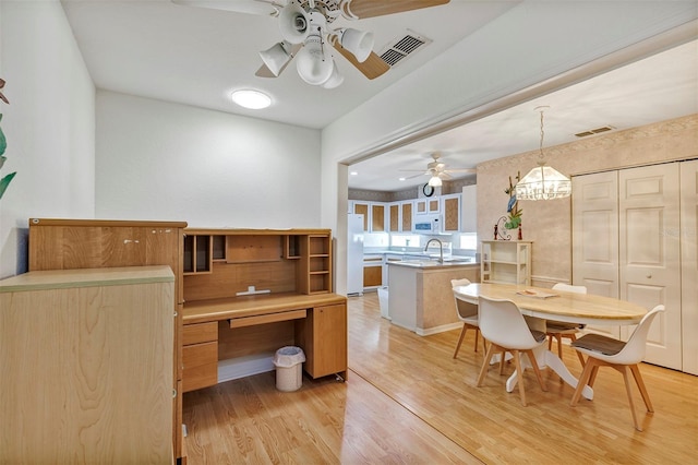 interior space featuring light hardwood / wood-style floors, sink, and ceiling fan