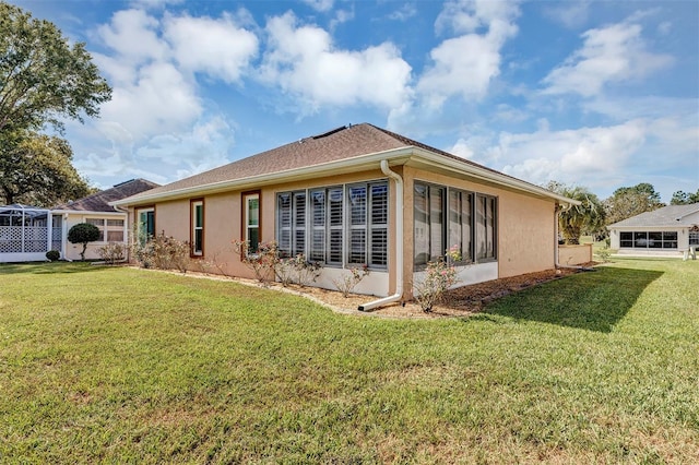 back of house with a lawn