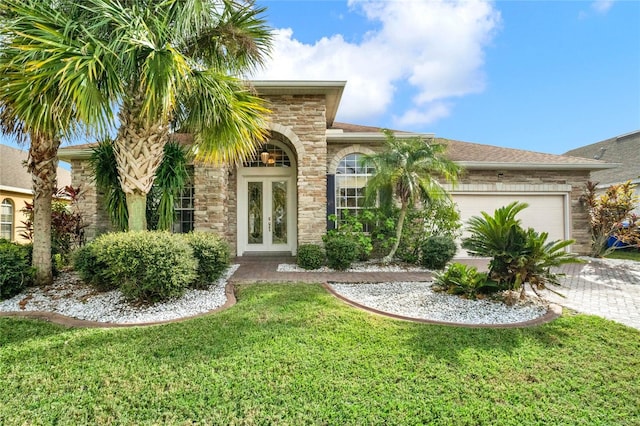 view of front facade with french doors, a front lawn, and a garage