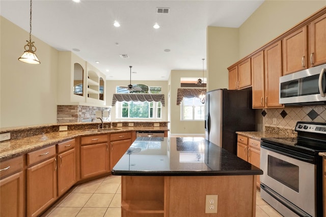 kitchen with stainless steel appliances, hanging light fixtures, light tile patterned floors, and a kitchen island