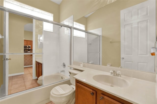 full bathroom featuring toilet, vanity, combined bath / shower with glass door, and tile patterned floors