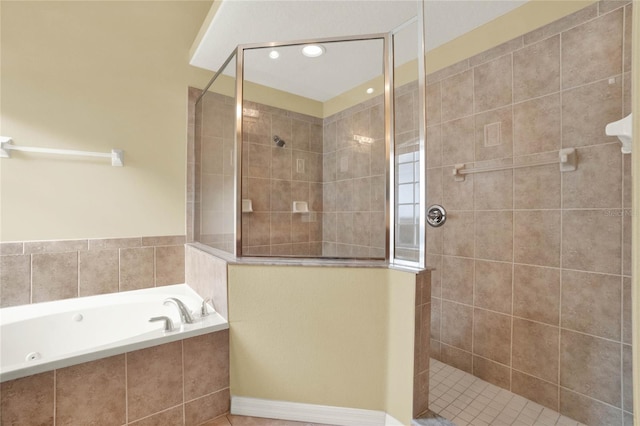 bathroom featuring tile patterned flooring and separate shower and tub