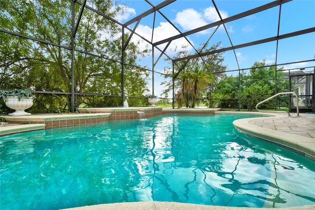 view of swimming pool featuring a patio, a lanai, and pool water feature