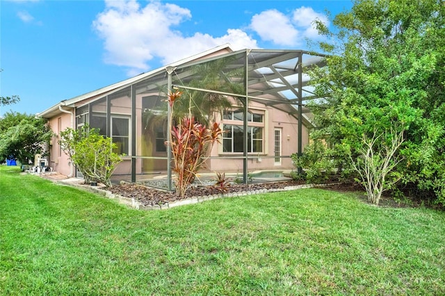 view of side of home featuring a lanai and a lawn