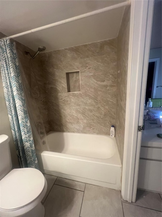 bathroom featuring toilet, shower / tub combo, and tile patterned flooring